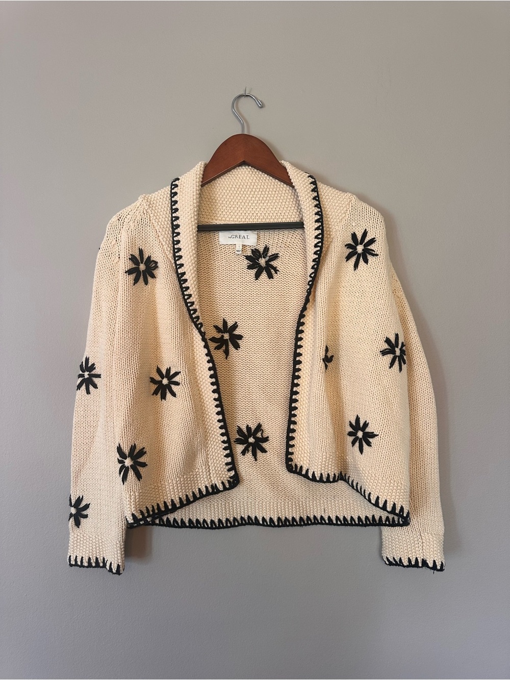 THE GREAT. Cream Open Cardigan with Black Flower Accents